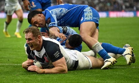 England's Thomas Burgess dives to score a try in the last minute of the match.
