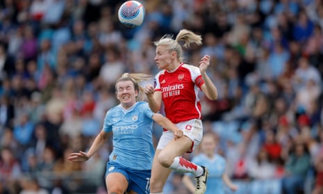 Lauren Hemp of Manchester City and Leah Williamson of Arsenal challenge for the ball.