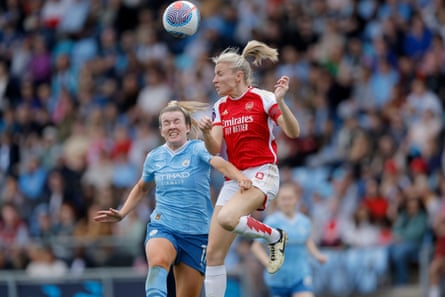 England teammates Lauren Hemp (left) and Leah Williamson battle for a high ball