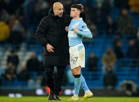 Manchester City’s head coach Pep Guardiola, left, and Phil Foden