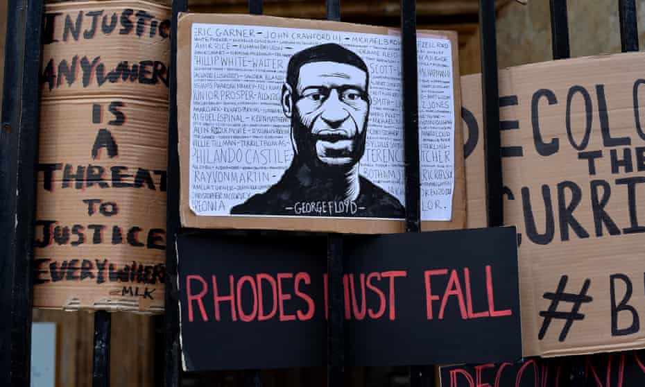 Placards left by protesters demanding the statue of Cecil Rhodes be removed from Oriel College, Oxford.