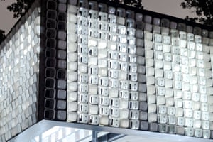 close-up of structure on building made of discarded white buckets