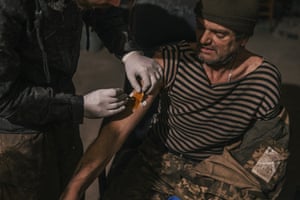 An injured soldier receives treatment.