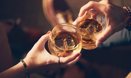 Cropped hands of friends toasting drinks in glass