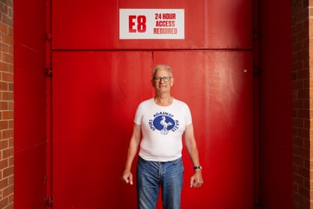 Richard Buckwell, a Tottenham fan who helped set up Spurs Against Nazis. He is wearing a Spurs Against Nazis T-shire standing against a red door.
