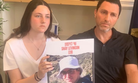 Mika Levinson and her father, Cochav William Levison, holding a picture of Shay.