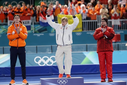Silver medalist Jenning de Boo of the Netherlands, gold medalist Jordan Stolz of USA and bronze medalist Laurent Dubreuil of Canada pose on the podium after the 500m final.