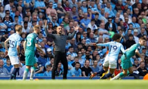 Manchester City manager Pep Guardiola throws some shapes on the touchline.