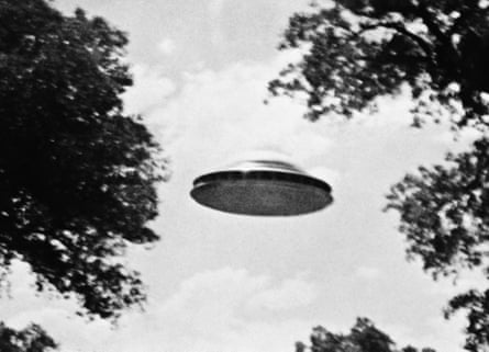 a saucer flies in a black and white photo