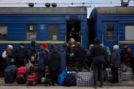 Volunteers of the East SOS non-governmental organisation help a woman to board an evacuation train in Pokrovsk, Ukraine on Tuesday.
