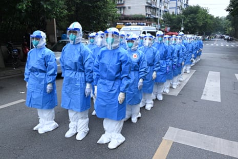 Health workers prepare to collect swab samples during a Covid-19 testing operation at a residential block in Chengdu, Sichuan province of China, 2 November 2021.