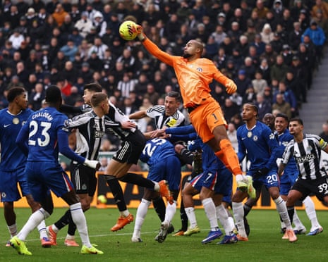 Chelsea's goalkeeper Robert Sanchez rises to punch clear.