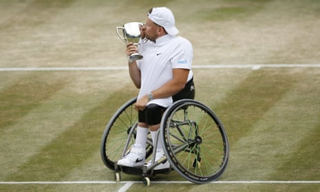 Dylan Alcott of Australia with the winner’s trophy at the Wimbledon tennis championships.
