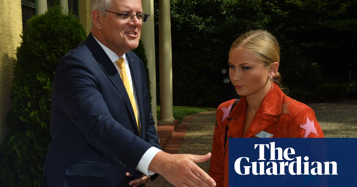 Grace Tame appears stony faced next to Scott Morrison during Australian of the Year photo op – video