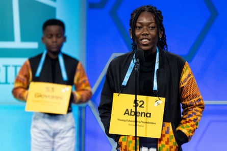 Wearing coordinating jackets, Abena Kwaffo, 13, of Accra, Ghana, right, spells her word as Giovanni Adjei, 10, also of Accra, waits for his turn during Tuesday’s preliminary rounds at the National Spelling Bee.
