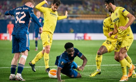 Bukayo Saka on the ground after Villarreal’s Manu Trigueros (left) was judged to have fouled the Arsenal winger, leading to a penalty.