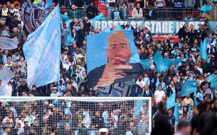 Manchester City fans display a flag featuring Pep Guardiola before the FA Cup final.