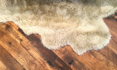 A rug on a wooden floorboard.