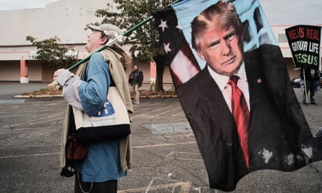 A far right rally attendee holds a Donald Trump flag in Portland, Oregon in August.