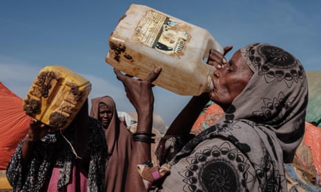 Women drink water at a distribution point at Muuri, one of 500 camps for the more than half a million people have now abandoned their homes in Somalia’s worst drought for 40 years.