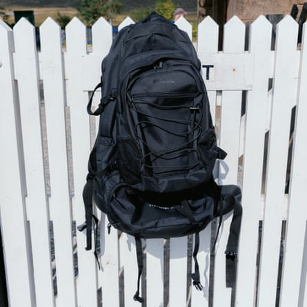 Mountain Warehouse Traveller 60l + 20l hung on a white gate