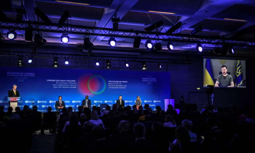 Russia-Ukraine war latest: fierce fighting in Sievierodonetsk; UK ‘deeply concerned’ by death sentences for Britons in Donetsk – live | World news 2 Ukrainian President Volodymyr Zelensky is seen on a giant screen as OECD Secretary General Mathias Cormann (R) speaks during a ministerial meeting at the Organisation for Economic Co-operation and Development (OECD) at the OECD headquarters in Paris on June 9, 2022.