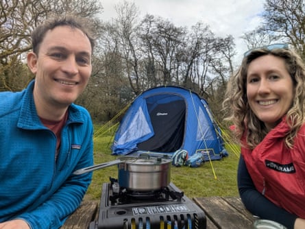 Man and woman selfie in front of a tent