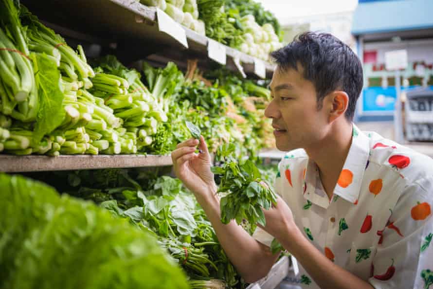 Asian greens distributor Thanh Truong admires some Thai basil.
