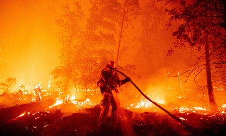 A firefighter douses flames during the Creek fire in the Cascadel Woods area of unincorporated Madera County, California, on 7 September 2020.