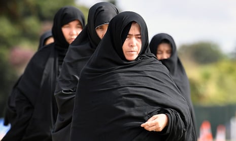 Mourners arrive for the funeral of a father and son during the first funerals for victims of the mosque shootings.