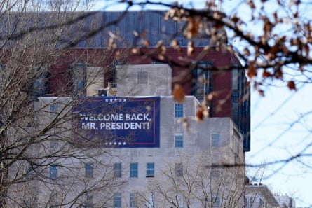 A sign on a building that reads ‘Welcome Back, Mr President’