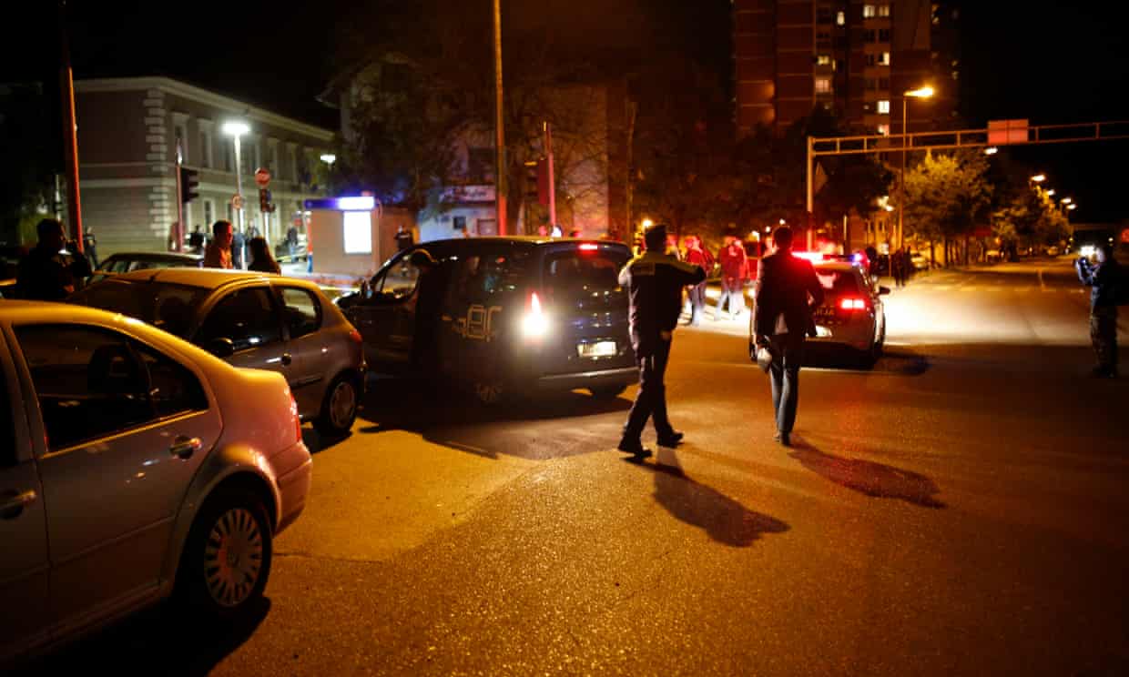 Officers secure an area near to a police station following a shooting in Zvornik.