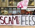 Protesting students hold a "SCAM! FEES" banner and an "Open the Books!" flag outside Goldsmiths