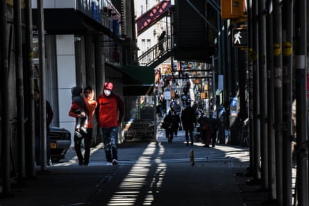 People wearing protective masks walk next to Myrtle Ave. in the Bushwick neighborhood of Brooklyn on April 2, 2020 in New York City. Currently, over 92,000 people in New York state have tested positive for COVID-19.