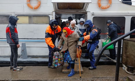 Civilians evacuated from the Russian-controlled city of Kherson walk from a ferry to board a bus heading to Crimea, in the town of Oleshky, Kherson region, Russian-controlled Ukraine October 23, 2022.