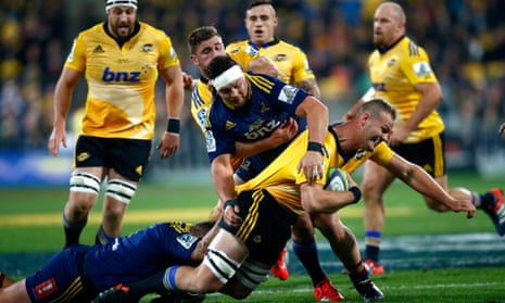 James Broadhurst of the Hurricanes is tackled by Brendon Edmonds.