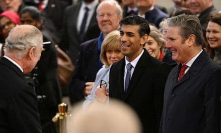 King Charles greets Rishi Sunak and Keir Starmer at the Houses of Parliament on 14 December.