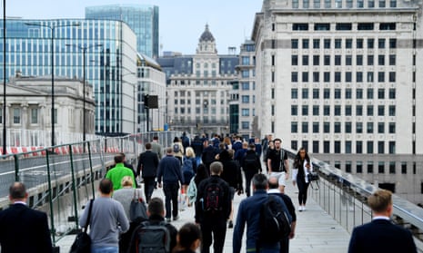 Office workers walking across London Bridge
