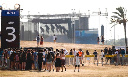 Fans wait to attend the outdoor concert by Radiohead.