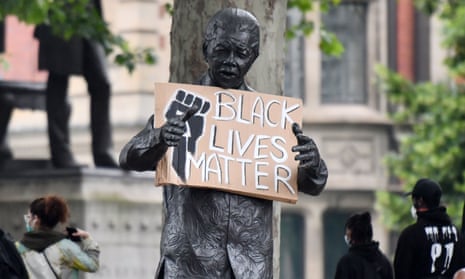 A statue of former South African president Nelson Mandela seen holding a Black Lives Matter placard