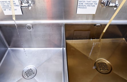 Two adjacent sinks with clear water and wastewater