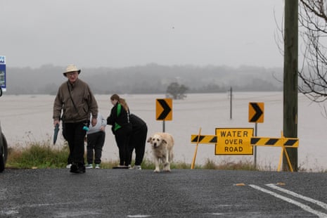 Dog and people overlooking flooded fields. Areas around the Hawkesbury-Nepean rivers such as Windsor have flooded again following three days of intense rainfall and floods across Sydney’s north-west.