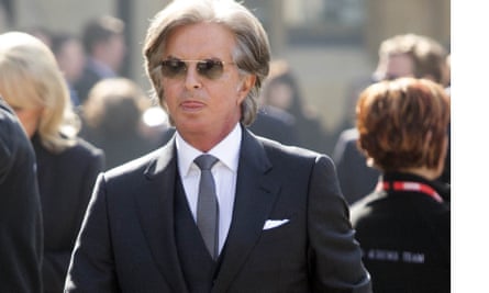 Richard Caring in sunglasses attending a memorial service