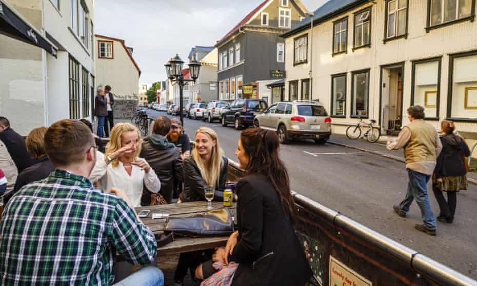 People have a drink at a bar in Reykjavik, Iceland, where equal pay is now being legally enforced.