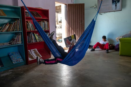 Marian Leonor Martinez, seven, in Atánquez library reads one of the books in a hammock.