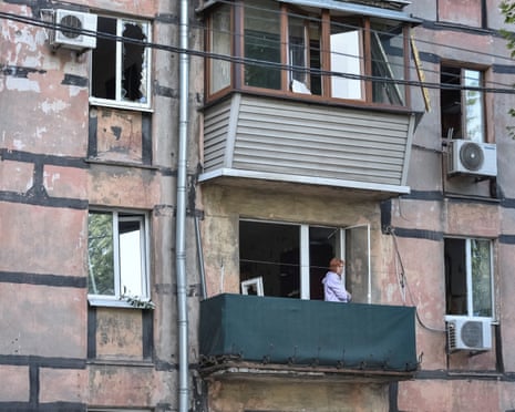 A woman stands on the balcony of her apartment in a residential building damaged during a Russian missile strike, amid Russia's attack on Ukraine, in Dnipro, Ukraine, on Saturday, 20 September 2025.