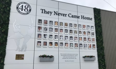 A memorial on a wall displays the pictures of the 48 people who died in the fire with the words ‘They Never Came Home’ at the top