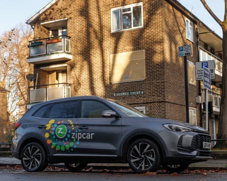 A Zipcar sits in its bay on a street in London.