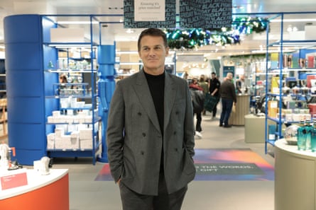 Peter Ruis at the John Lewis store in the Bluewater shopping centre. He stands in front of homeware displays and wears an unbuttoned dark grey double-breasted suit jacket.