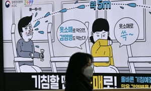 A woman wearing a face mask walks past a poster in Seoul, South Korea, showing preventative measures against infectious diseases. A woman wearing a face mask walks past a poster in Seoul, South Korea, showing preventative measures against infectious diseases.